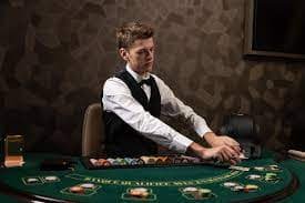 MotoGP race weekend coverage displayed on a mobile phone alongside live dealer blackjack table